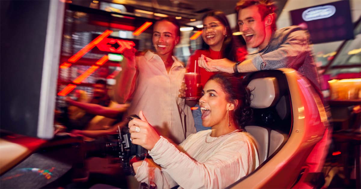 group of people enjoying arcade games